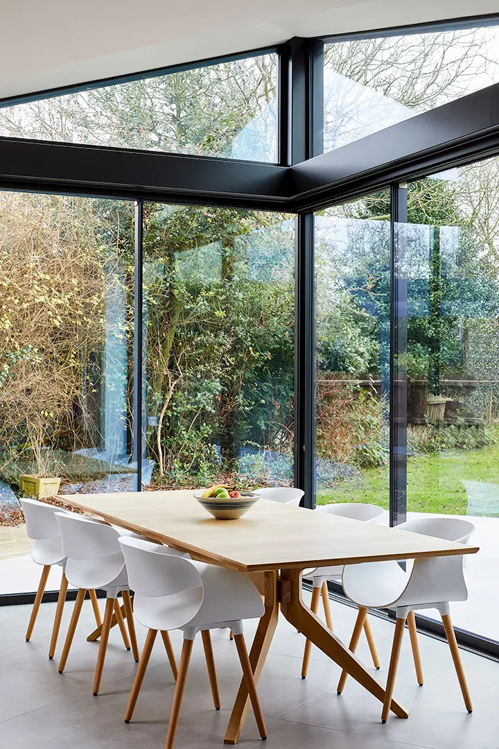 Dining area wrapped in minimal framed glazing