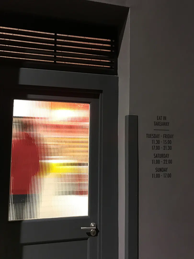 S&H restaurant entrance and opening-hours lettering