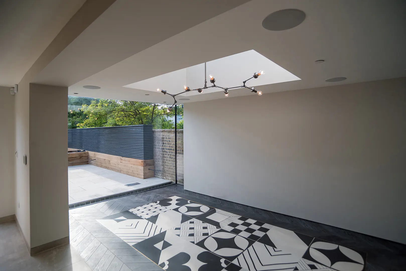 Contemporary lower-ground-floor living space opening to the terrace