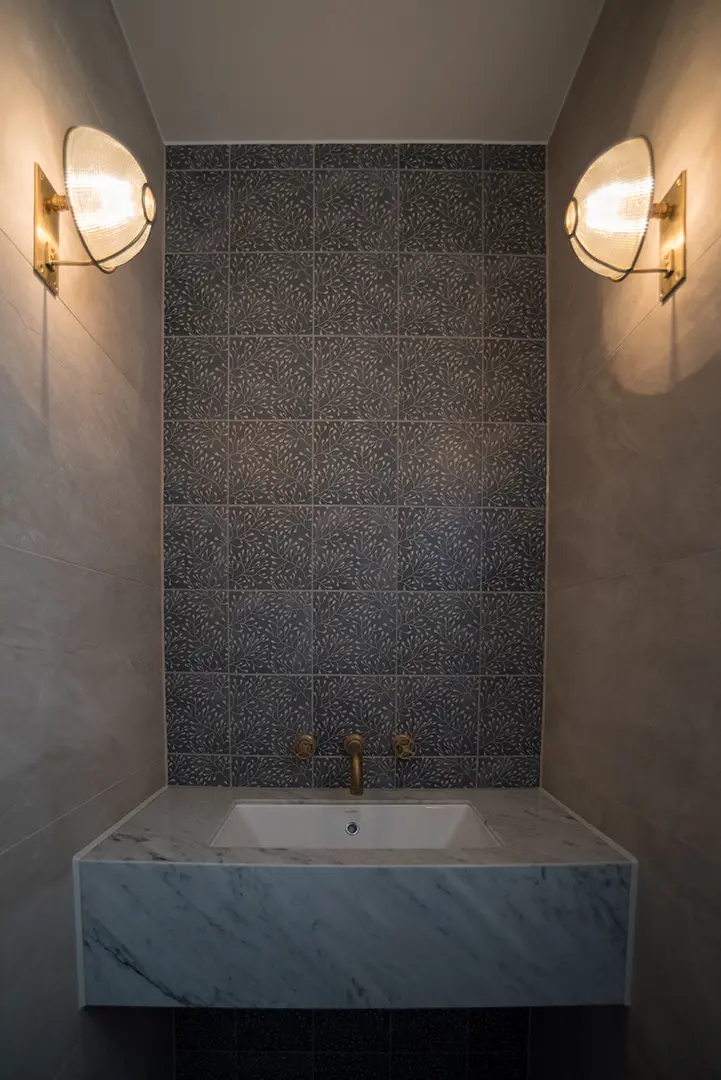 Marble-clad bath with warm wall lighting